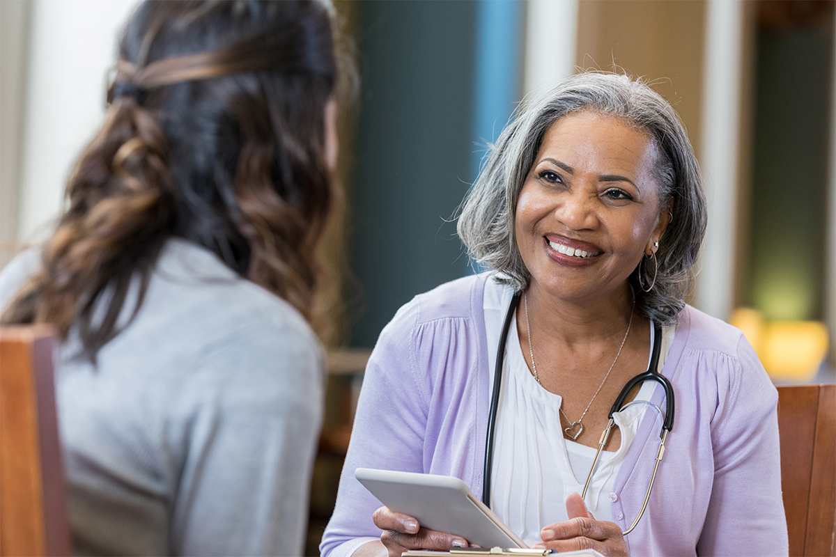 older-female-clinician-talking-with-patient.jpg